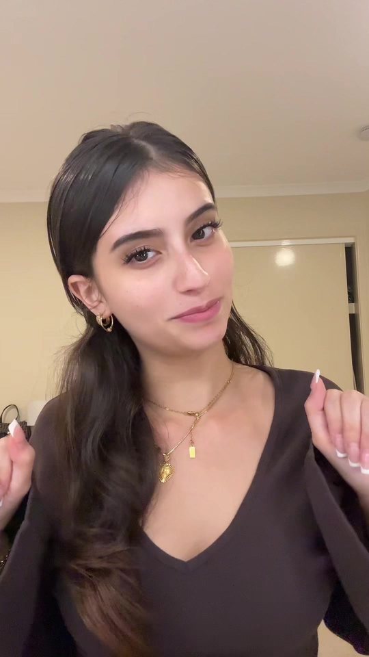Video cover: Aisha talking to camera in a brown top.